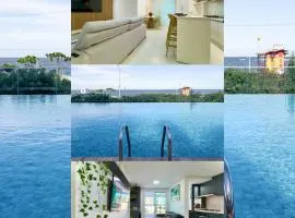 Apto Pé na Areia Condomínio Resort Completo com Piscina borda Infinita, Beach Tennis, Academia, Sala de Jogos, Brinquedoteca, Playground e Portaria 24H 2 Quartos com Ar-Condicionado, Churrasqueira Privativa Reserve Agora e Viva essa Experiência