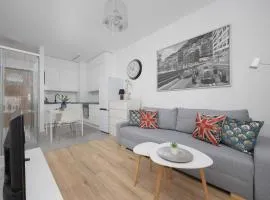 Bright Grey Apartment in Warsaw with Balcony by Noclegi Renters