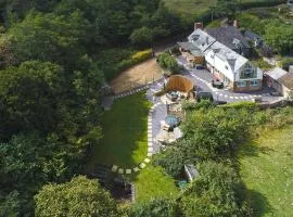 Private lodge spa, sauna, hot tub, outdoor kitchen with firepit area