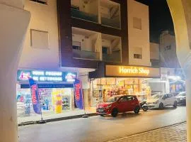 A one-bedroom apartment with a living room, kitchen, and balcony