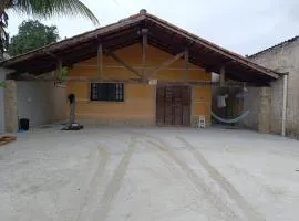 House with Atlantic Forest in the background - Saíra Sete Cores