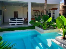 Private 8 Sleeper Waterfall Villa with private garden and cascading waterfall pool in Paje Zanzibar Prime location steps to Paje beach shops bars & restaurants WIFI AC TV, hotel in Paje