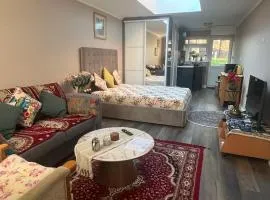 Cosy self-contained extension with skylight & garden view