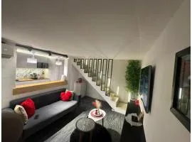 Modern and warm studio with designer staircase