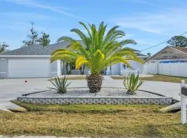 Contemporary coastal escape with heated pool, fenced yard, & outdoor dining