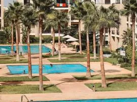 Magnifique appartement familial a Prestigia offrant une vue panoramique exceptionnelle sur trois piscines Idealement situe a seulement 5 minutes a pied de la Plage des Nations et a 20 minutes en voiture de Rabat