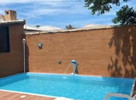 Casa de praia veraneio com piscina e área de jogos