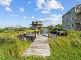Waterfront home with boat dock, shared pool, & balcony with ocean view