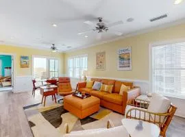 Vibrant beach retreat with washer/dryer, central AC, deck, & pool access