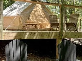 Peaceful Glamping Tents with Elevated Decks, Cozy Fire Pit, and Secluded Forest Views Near Gentry, AR