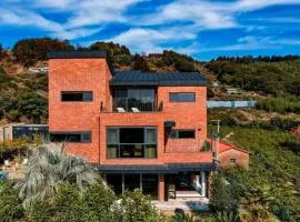 투워즈 Seogwipo central three story private villa, tangerine field cherry blossom and canola flower festival road in front of the house, large family accommodation, five minutes to Olle Market, near Jungmun Tourist Complex