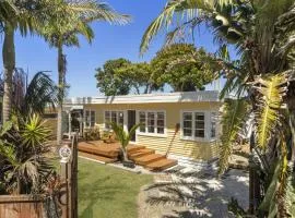 Across the Road from the Sand Classic Kiwi Bach