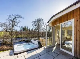 Lovely river fronted lodge with hot tub