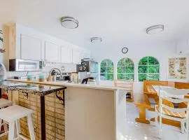 Tree-lined coastal home with children's items gas grill and washer&dryer