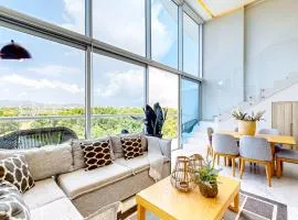 Luxe condo with infinity pool, fitness center, sweeping vistas, and central AC