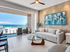 Modern waterfront condo with shared pool, balcony, and washer/dryer