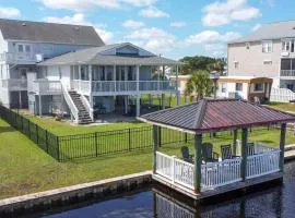 Explore Surf City from this spacious 6-bedroom, canal-front home, perfect for families
