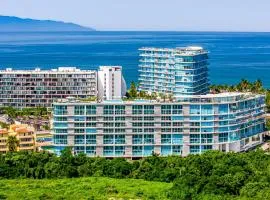Ocean-view condo with balcony, central AC, pool, gym, cinema, & bar