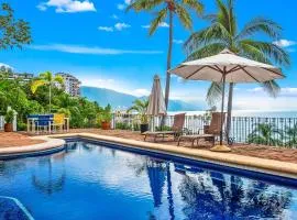 Bright ocean-view 2-story condo near beach with pool, balcony & full kitchen