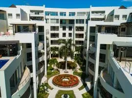 Modern ocean-view stay with pool and rooftop access, large balcony, and AC