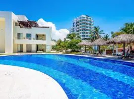 Ocean-view condo with pools, roof deck, lounge, private balcony, & AC