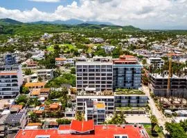 Modern waterfront condo with shared pool, balcony, and washer/dryer