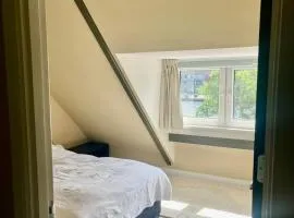 Private attic room with workspace & water view