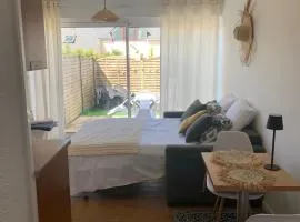 Waterfront studio with small garden, pool, parking
