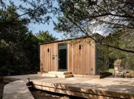 Whimsical Flower-Inspired Mirror Cabin by the Lake in the Enchanted Forests of Texas