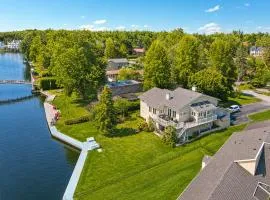 Canalside Summer Cottage with Waterview, Custom Bar, BBQ, and Fireplace