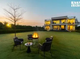 StayVista at Olive Farms with Lawn, Pool, Bonfire & Hill Views