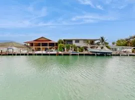 Dog-friendly waterfront home with dock, pool, gas grill, & beach access