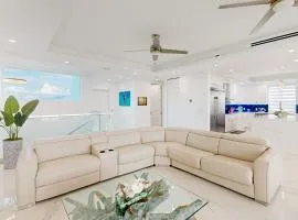 Sprawling waterfront home with pool, outdoor kitchen, game table, grill, & W/D