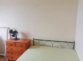 Large bedroom in a private host house with shared bathroom, garden, veranda, and free private parking