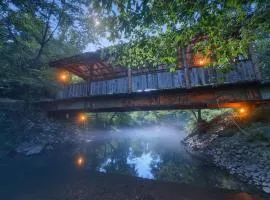 Covered Bridge Tiny Home Bus on the water in RRG