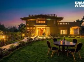 StayVista at Vannraj Farm Villa with Shared Pool & Bonfire