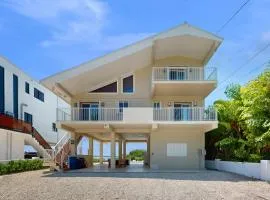 Oceanfront home with a pool, dock, grill, scenic balconies, games, WD, & AC