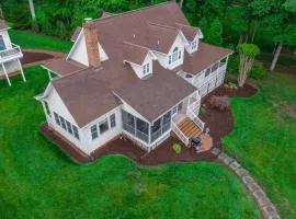 Lakefront home with private dock, kayaks, beach, badminton, firepit, & deck