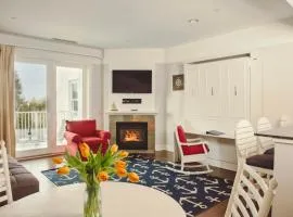 Experience luxury at Captain Suite 219 in Bay Harbor, MI, featuring a cozy bedroom and village view.