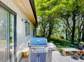 Water-view retreat with beach access, deck, grill, EV charger & lawn games