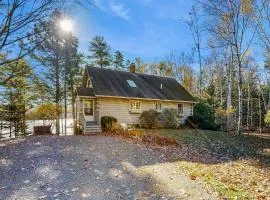 Charming riverfront home with cozy interiors, dock, and scenic deck views
