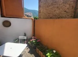 Room with flower-filled patio in the heart of the village
