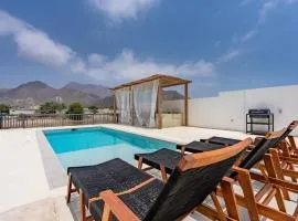 Escape to a Boho-Style 3BR Villa with Assistant Room, Private Pool, Pergola, and Breathtaking Mountain Views, Al Dana Island, Fujairah by Deluxe Holiday Homes