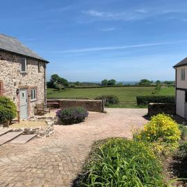 The Granary at Pentregaer Ucha, tennis court & lake.