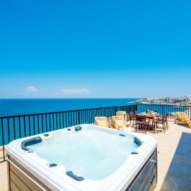 Islet Promenade Seafront Penthouse with breathtaking seaviews and private hot tub on the large terrace by Getawaysmalta