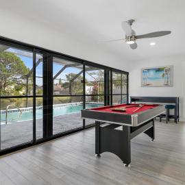 Tropical Tranquility! Luxury pool home with lakefront view just minutes from the beach!
