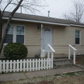 1 bedroom with a fireplace close to base