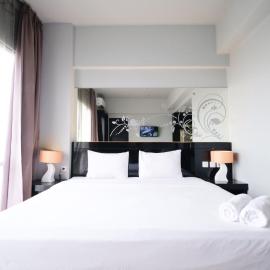 Homey Studio No Kitchen at Grand Darmo Suite Apartment By Travelio