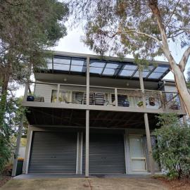 Holiday house among native trees overlooking wetlands