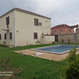 A two-storey cozy house with a pool